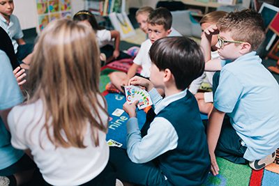 lower schoolers playing card game