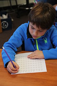 fourth grader learns to write braille