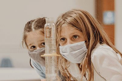 lower school students studying science experiment
