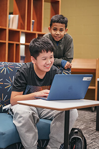 middle school students working together in the library