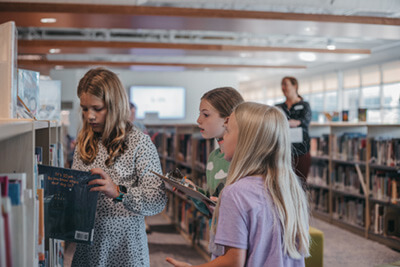 middle school students together in the library